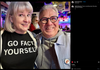 A smiling man and woman pose for a photo in a bar; the woman wears a union made Go Fact Yourself t-shirt.