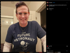A person wearing glasses and a RAYGUN apparel navy blue t-shirt that says Former Future Astronaut above an illustration of a cat holding a telescope.