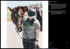 A person wearing a wide-brimmed helmet and a green, eco-friendly T-shirt reading Needs National Parks stands next to a horse wearing a bridle and saddle.