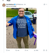 A smiling man wearing glasses and a blue jacket over a RAYGUN t-shirt that says, I’m going to stop drinking just as soon as I’m named Secretary of Defense.