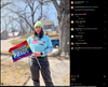 A person wearing a neon green beanie and a union made t-shirt that says Trans people belong in Iowa holds a small pride flag that reads Decorah Pride.
