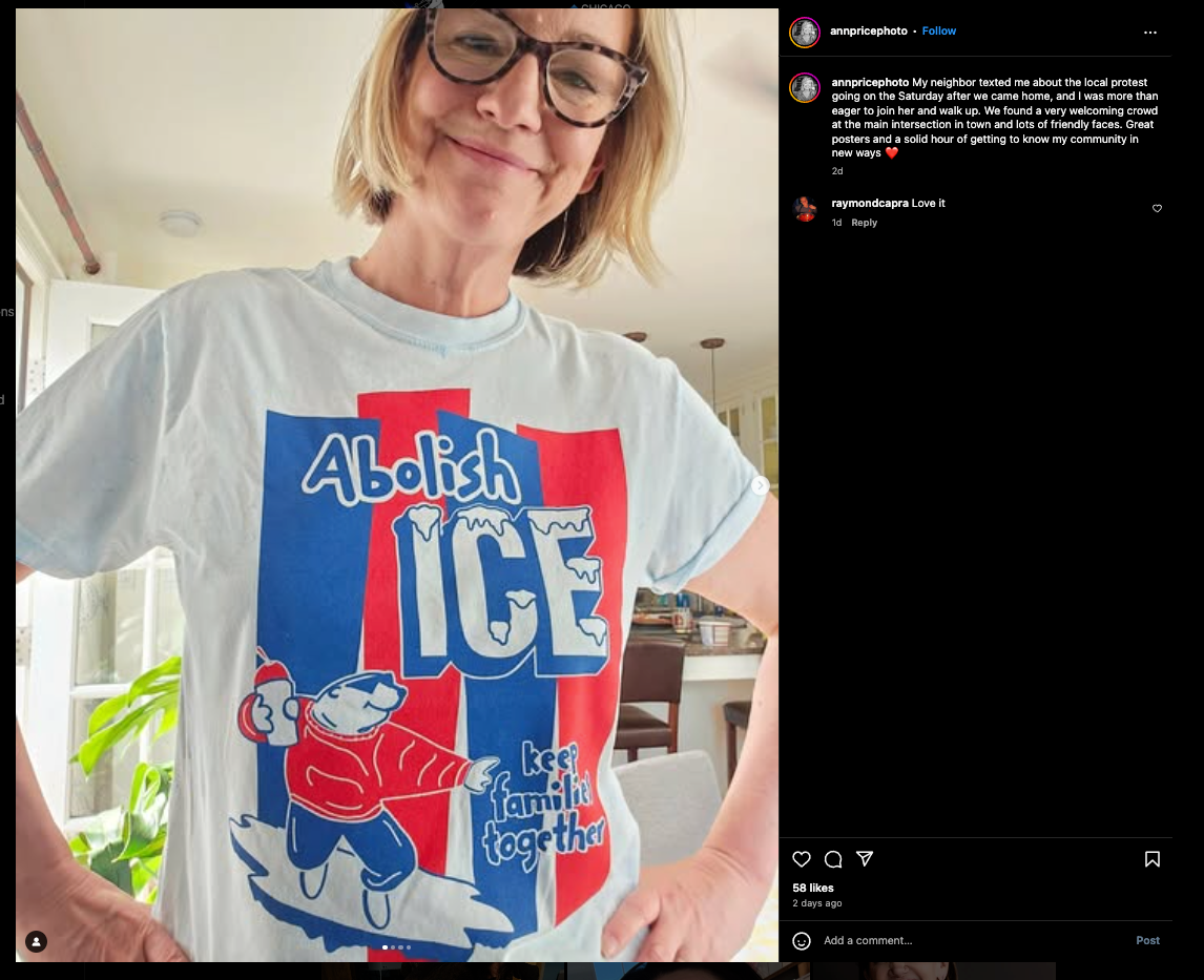 A person wears a light blue union made t-shirt featuring a cartoon of a character holding a child with the text Abolish ICE and Keep families together.