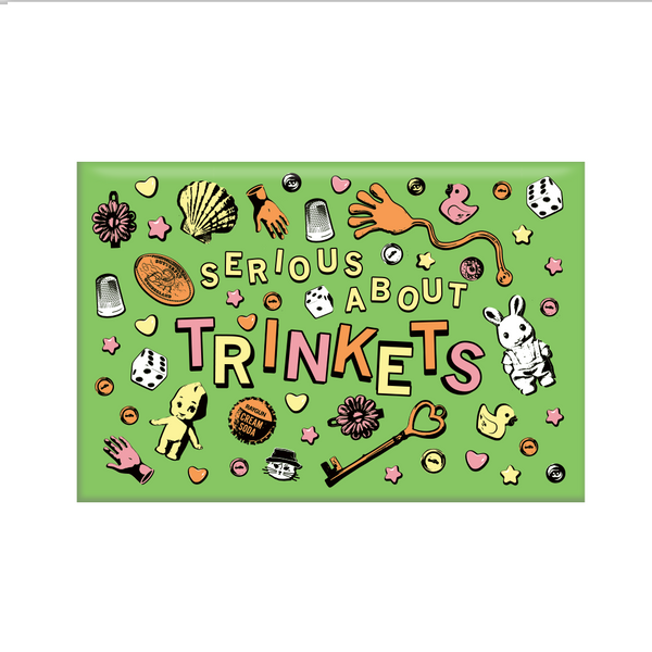 A rectangular green magnet with pastel pink, yellow, and orange print. Text in the center says, 