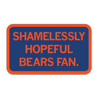 A navy rectangular sticker with rounded corners, an orange boarder, and orange text that says, "Shamelessly Hopeful Bears Fan"