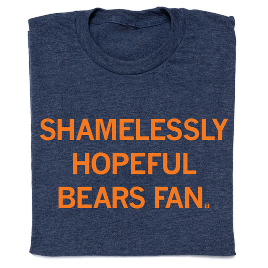 Folded heather navy t-shirt with centered orange print that says, "Shamelessly Hopeful Bears Fan" in all caps.
