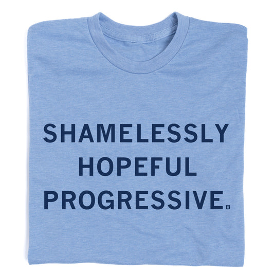 Light blue crew-neck progressive t-shirt with the text SHAMELESSLY HOPEFUL PROGRESSIVE. printed in dark blue.
