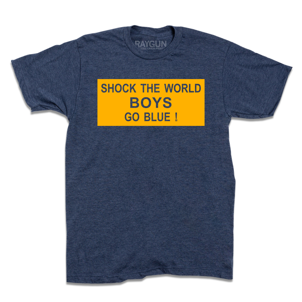 Heather denim t-shirt with a gold ink rectangle printed around the text "Shock the world
boys
Go blue!"