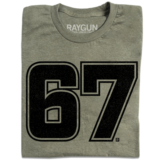 A folded heather military green shirt with giant "67" printed in black ink in the center.