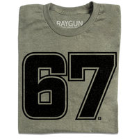 A folded heather military green shirt with giant "67" printed in black ink in the center.