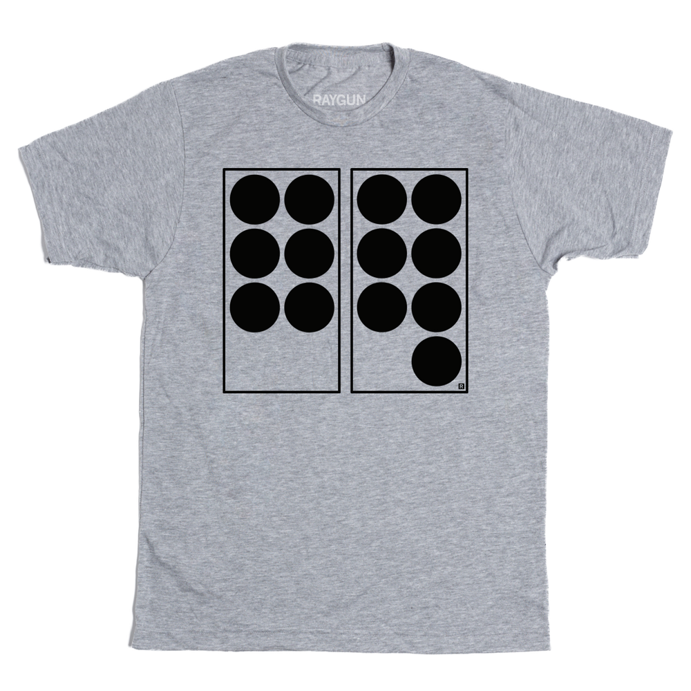 A heather grey t-shirt with black ink depicting two vertical rectangles side-by-side. The one on the left has six black dots in it while the one on the right has seven. Referencing the 6 7 meme.