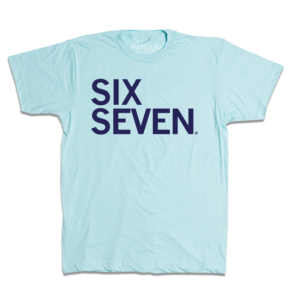 A heather light blue shirt with navy left-aligned text that says, "Six Seven"