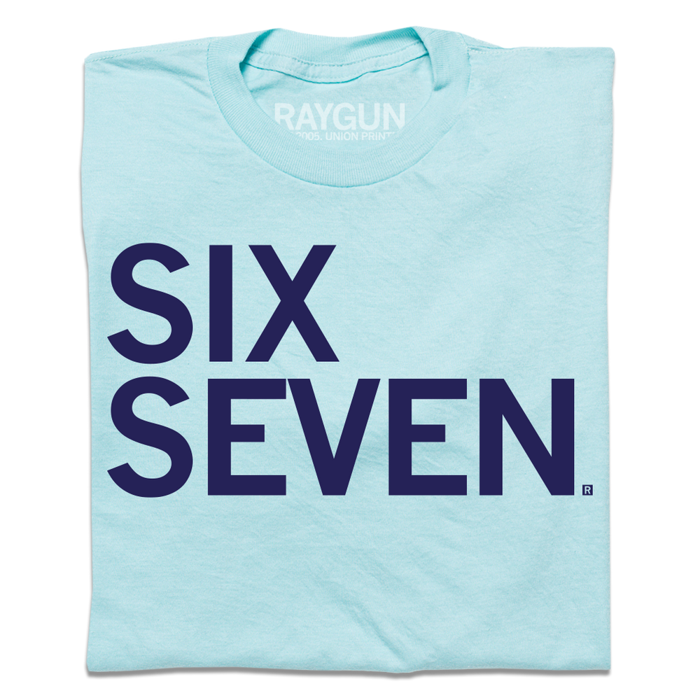 Light blue t-shirt with navy left-aligned text that says, "Six Seven"