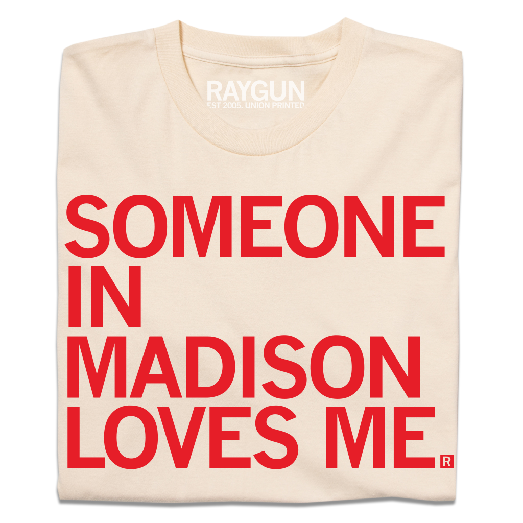 Cream-colored, union made t-shirt with the red text SOMEONE IN MADISON LOVES ME. printed on the front.