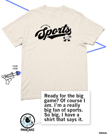 Off-white t-shirt featuring a black graphic that says REALLY BIG FAN Sports with a cartoon character, alongside a quote bubble about being a big fan of sports.
