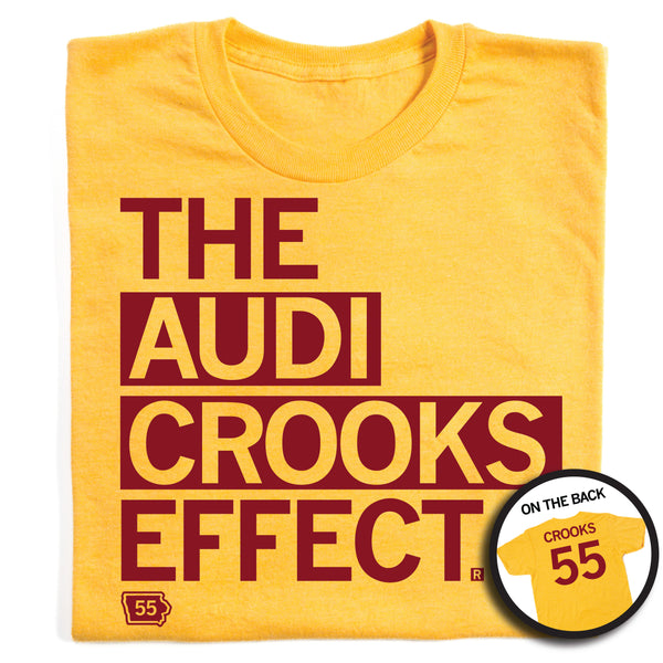 A folded heather yellow shirt with left-aligned cardinal ink that says, 