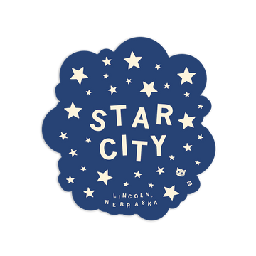 A navy blue Star City vinyl sticker with a cloud-like edge, featuring cream-colored text reading STAR CITY and LINCOLN, NEBRASKA, surrounded by stars and a small cat face.