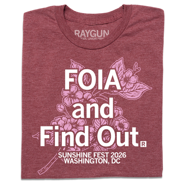 A folded heather burgundy t-shirt with white ink text that reads 