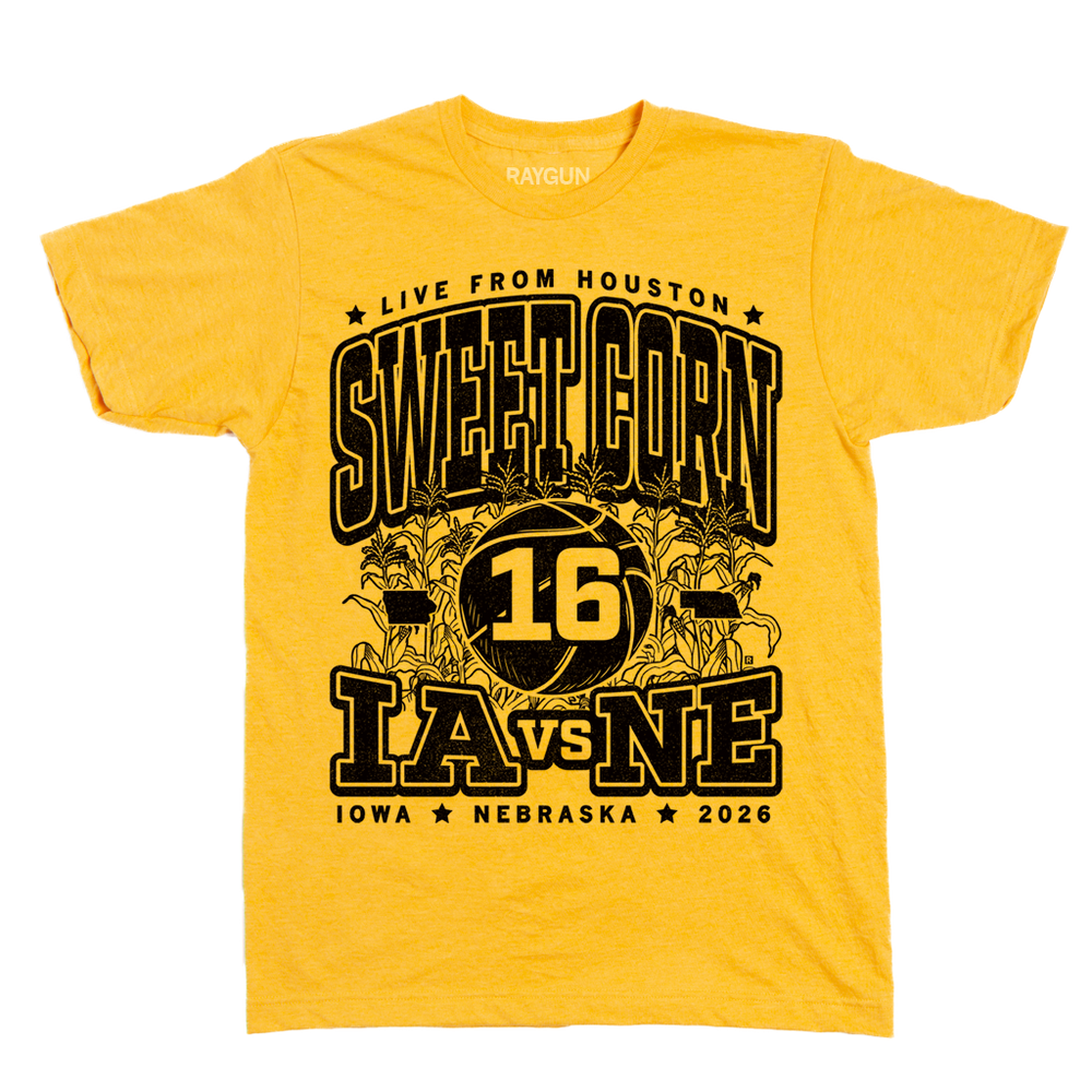 Heather  gold t-shirt with black ink text that reads "Live from Houston: The Sweet Corn 16. IA vs NE. Iowa, Nebraska 2026." In the center of the shirt is a basketball with the number 16 on it, Iowa to the left, Nebraska to the right, and corn growing behind it.