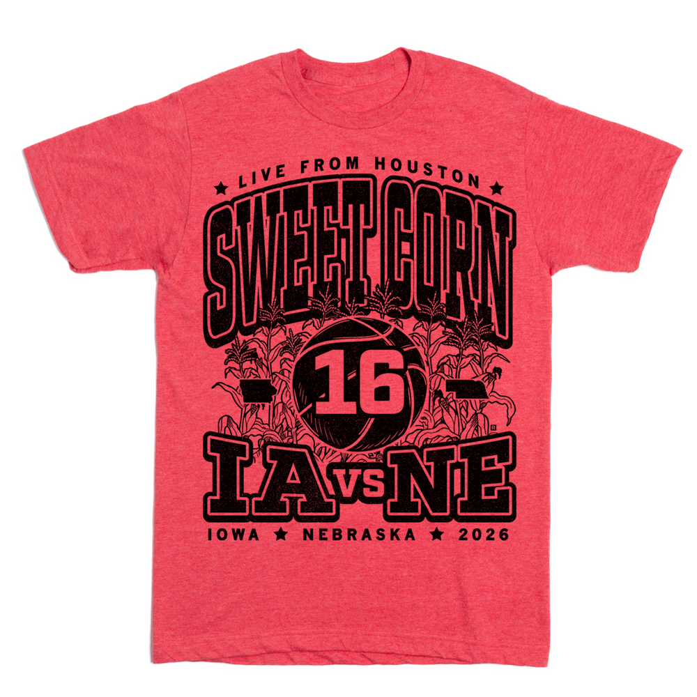 A heather red t-shirt with black ink text that reads "Live from Houston: The Sweet Corn 16. IA vs NE. Iowa, Nebraska 2026." In the center of the shirt is a basketball with the number 16 on it, Iowa to the left, Nebraska to the right, and corn growing behind it.