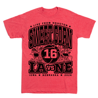 A heather red t-shirt with black ink text that reads "Live from Houston: The Sweet Corn 16. IA vs NE. Iowa, Nebraska 2026." In the center of the shirt is a basketball with the number 16 on it, Iowa to the left, Nebraska to the right, and corn growing behind it.