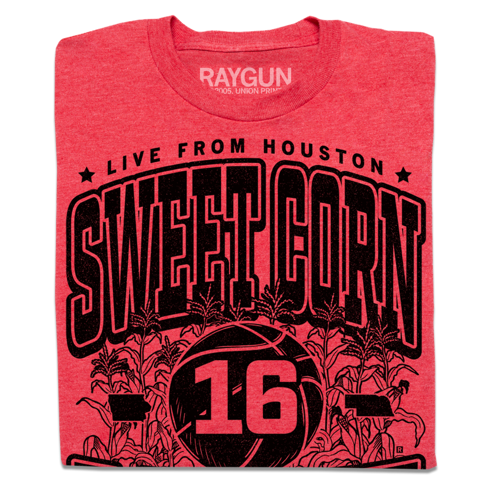 A folded heather red t-shirt with black ink text that reads "Live from Houston: The Sweet Corn 16. IA vs NE. Iowa, Nebraska 2026." In the center of the shirt is a basketball with the number 16 on it, Iowa to the left, Nebraska to the right, and corn growing behind it.