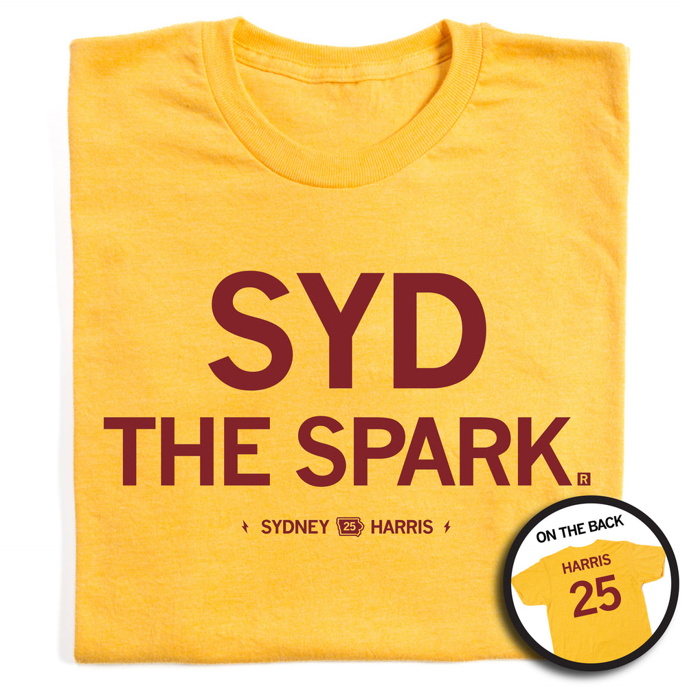 A folded heather gold t-shirt with cardinal ink that reads "Syd The Spark" over "Sydney 25 Harris" on the front. The back is laid out like a jersey and says, "Harris 25"