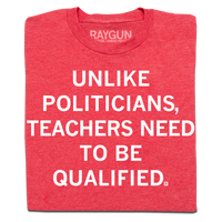Folded heather red shirt with white ink text that reads "Unlike politicians, teachers need to be qualified"