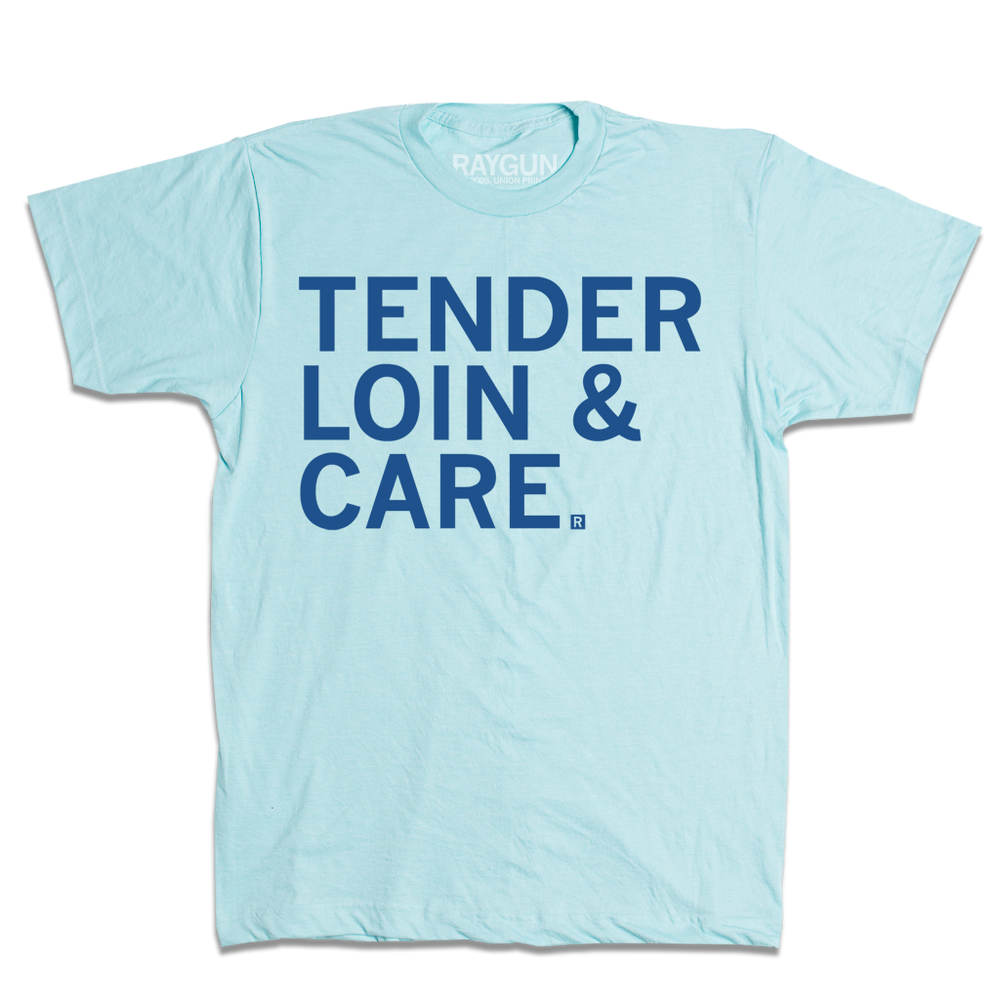 Short sleeve light blue t-shirt with left-aligned royal blue print that reads "Tender Loin & Care"
