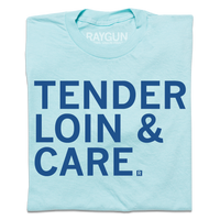 A folded pastel blue shirt with royal blue text that says, "TENDER LOIN & CARE."