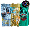An image of three shirts laid side-by-side with a bunch of different designs printed all over them and a text bubble in the corner that says, "Test Shirts. One-of-a-kind"