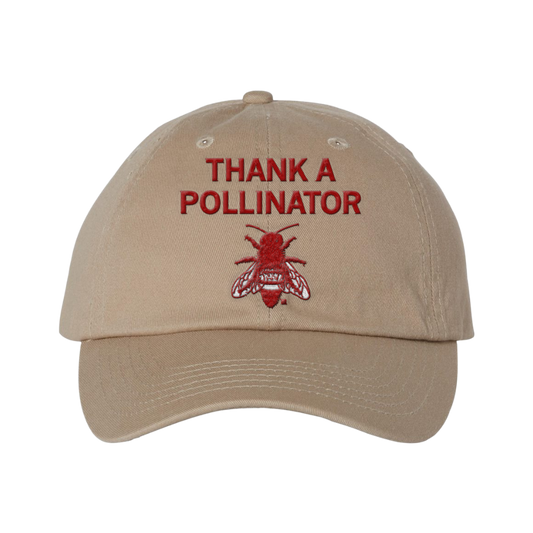 Tan six-panel twill baseball cap featuring the text THANK A POLLINATOR above an embroidered red bee.