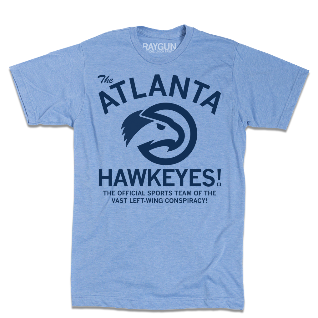 A heather light blue t-shirt with navy ink that reads "The ATLANTA HAWKEYES! The Official Sports Team Of The Vast Left-Wing Conspiracy!" With a bird logo in the center.