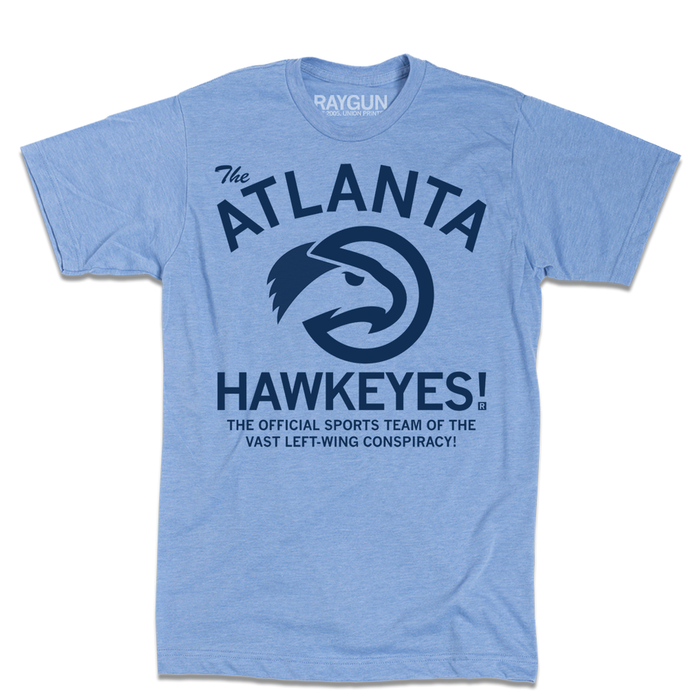 A heather light blue t-shirt with navy ink that reads "The ATLANTA HAWKEYES! The Official Sports Team Of The Vast Left-Wing Conspiracy!" With a bird logo in the center.