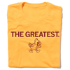 A folded gold t-shirt with centered cardinal print that says, "THE GREATEST" above a vintage Cy Iowa State logo of Cy angrily walking to the right.