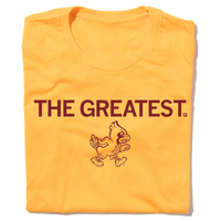 A folded gold t-shirt with centered cardinal print that says, "THE GREATEST" above a vintage Cy Iowa State logo of Cy angrily walking to the right.