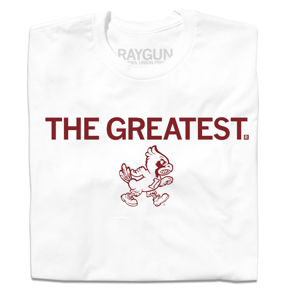 A folded white t-shirt with cardinal print text that says, "THE GREATEST" above a vintage Cy Iowa State logo of Cy walking to the right.