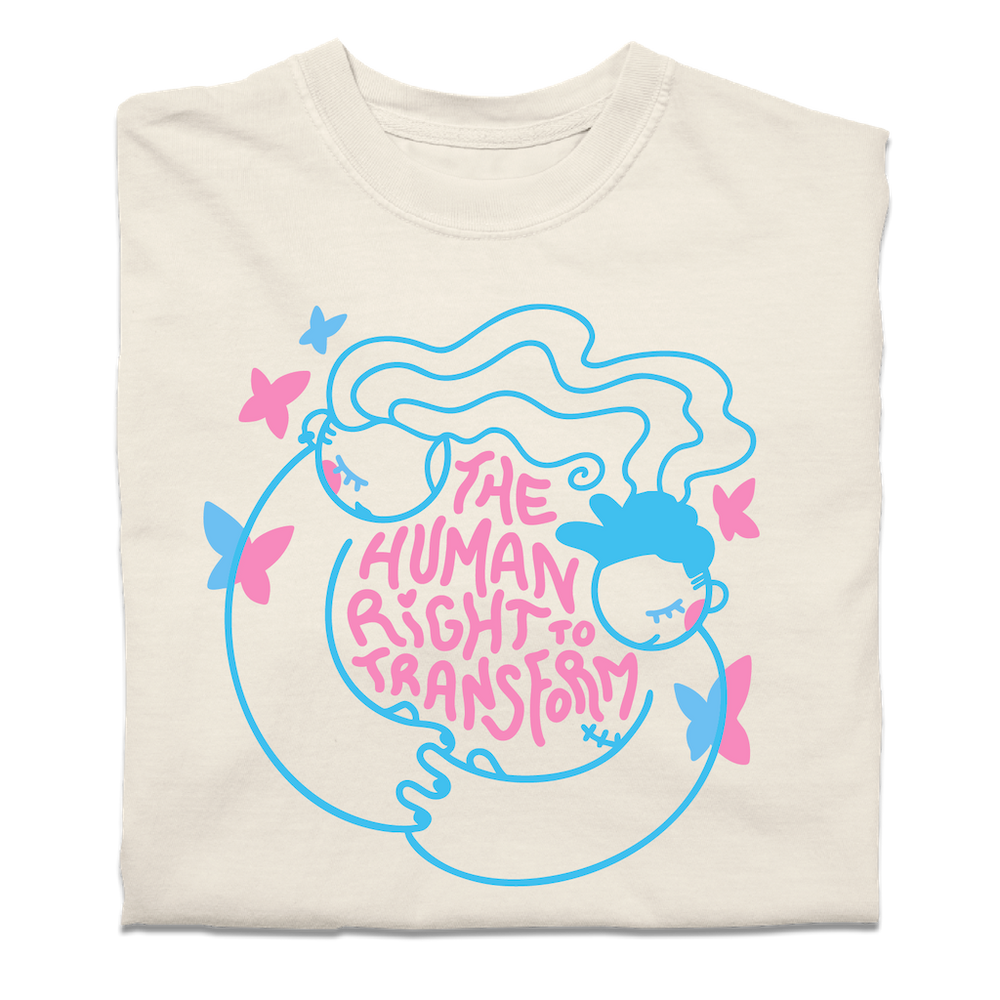 A folded off white t-shirt with neon pink and blue print depicting two people holding hands around text that says, "The Human Right To Transform" with some butterflies flying around the sides.
