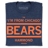 Folded heather navy t-shirt with orange ink print that says, "The I'm From Chicago Bears. Hammond Indiana"