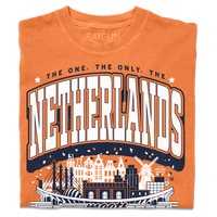 A folded orange heavyweight t-shirt with navy and white ink. Text from the top to the bottom reads "The one, the only, The Netherlands meets Kansas City. World Cup 2026, Missouri." In the center is an illustration depicting notable places from The Netherlands and Kansas City blended together.