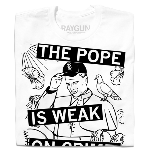 White RAYGUN t-shirt featuring a black and white graphic of the Pope wearing a Chicago White Sox cap with a pigeon on his shoulder and the text THE POPE IS WEAK ON CRIME.
