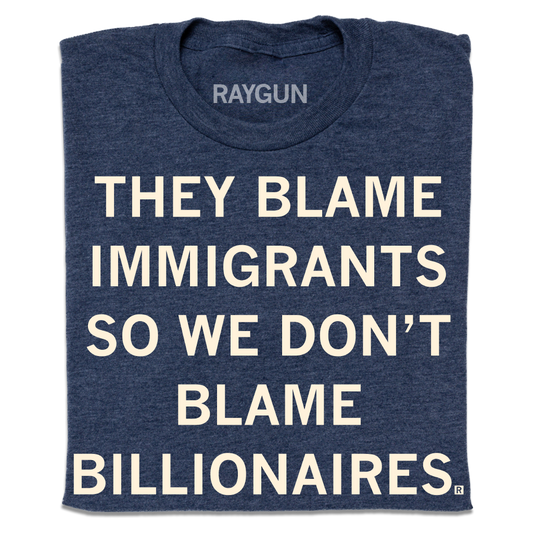 Navy blue heather denim T-shirt with the white text THEY BLAME IMMIGRANTS SO WE DONT BLAME BILLIONAIRES.