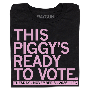 Folded black t-shirt with light pink ink that says, "This piggy's ready to vote. Tuesday, November 3rd 2026. LFG!"