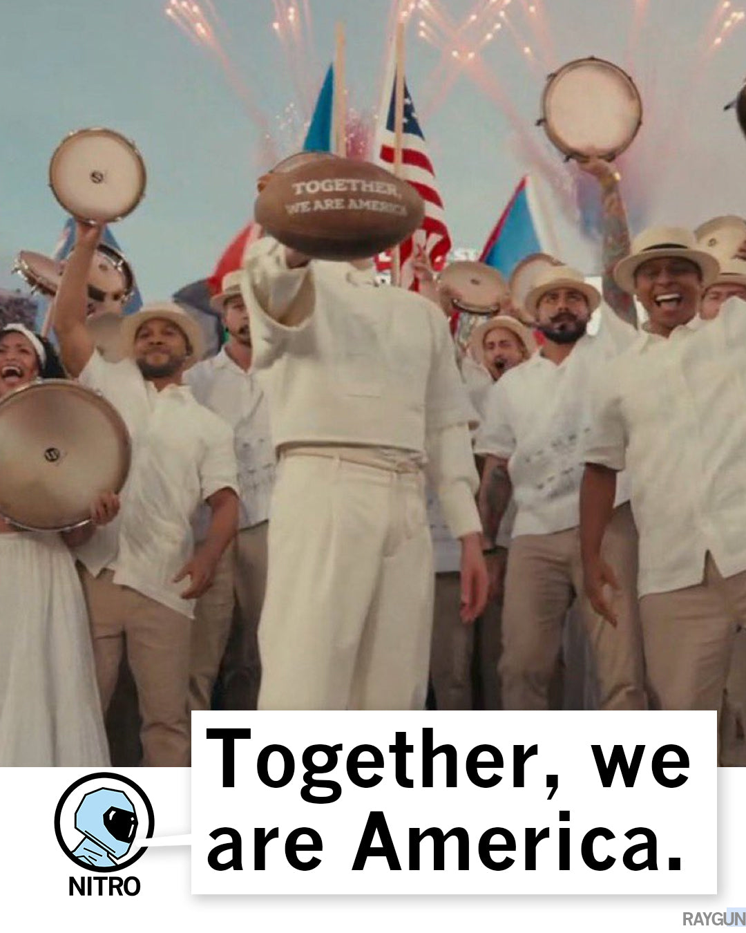 A person holds up a football labeled Together, we are America in front of a celebratory crowd holding tambourines, printed on a garment-dyed heavyweight t-shirt with the text Together, we are America. at the bottom.