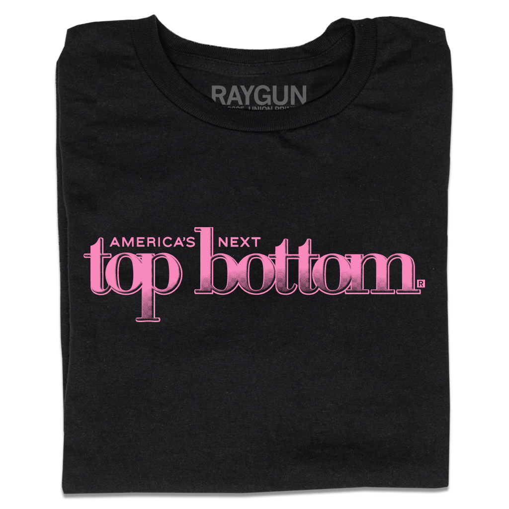 A folded black t-shirt with pink ink that reads "America's Next Top Bottom."