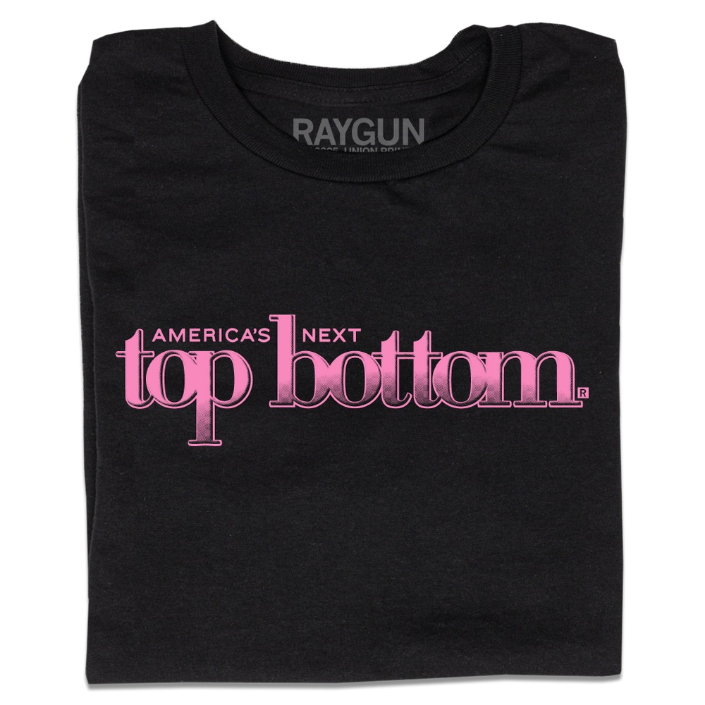 A folded black t-shirt with pink ink that reads "America's Next Top Bottom."