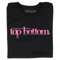 A folded black t-shirt with pink ink that reads "America's Next Top Bottom."
