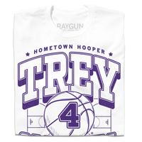 A folded white t-shirt with purple ink that reads "Hometown Hooper. Trey Campbell. Guard. Cedar Falls" over an illustration of a basketball court with a giant basketball in the center that has the number 4 on it.