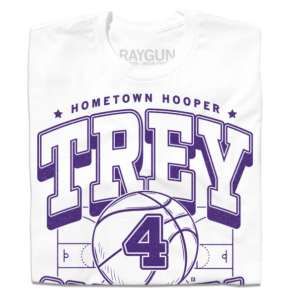 A folded white t-shirt with purple ink that reads 