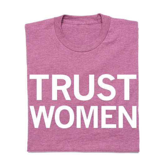 A mauve Trust Women t-shirt from the Reclaim Project with the words printed in white capital letters.