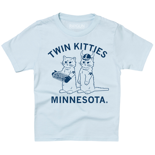 Light blue Union Made t-shirt with a graphic of two cats labeled Twin Kitties Minnesota, with one cat holding a hotdish and the other wearing a horned helmet.